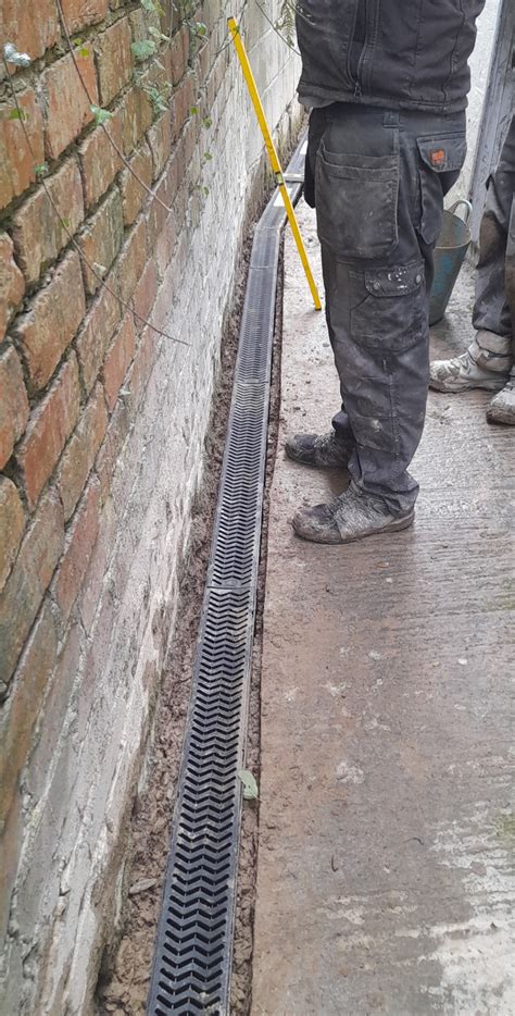 aco drain against house